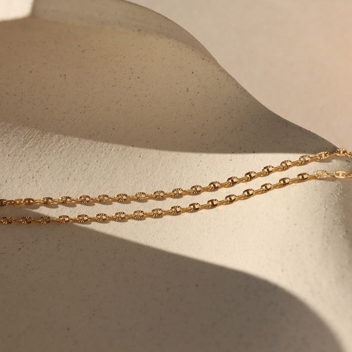 14k gold fill sparkly chain on a light dish