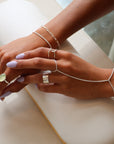 model wearing sterling silver hand chain with other sterling silver jewelry