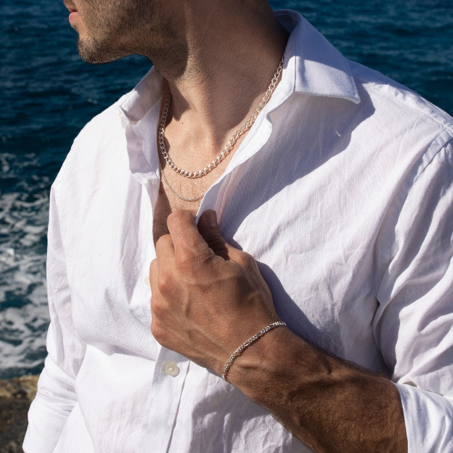 Model wearing 925 sterling silver Alex chain paired with la mer chain.