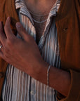 Model wearing 925 sterling silver Gio bracelet. 