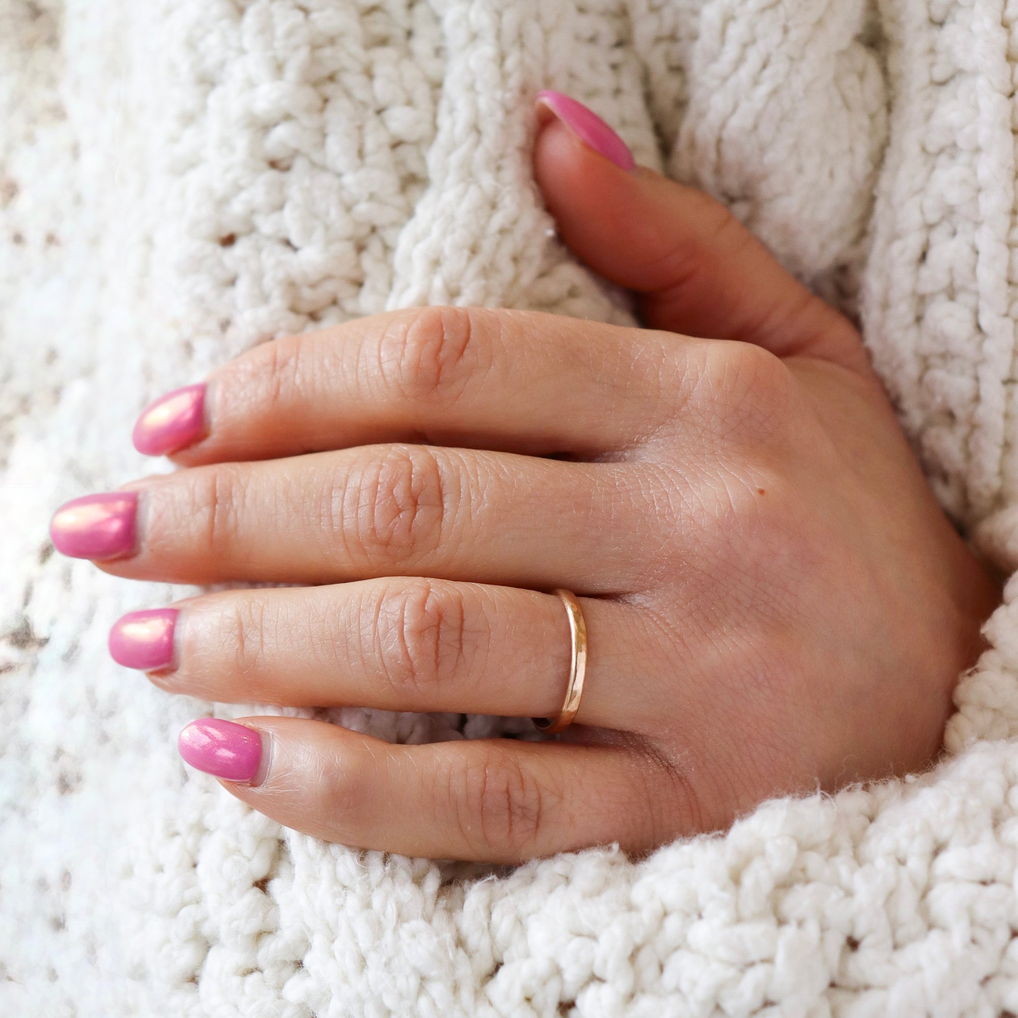 model wearing lightly hammered circle ring in 14k solid gold