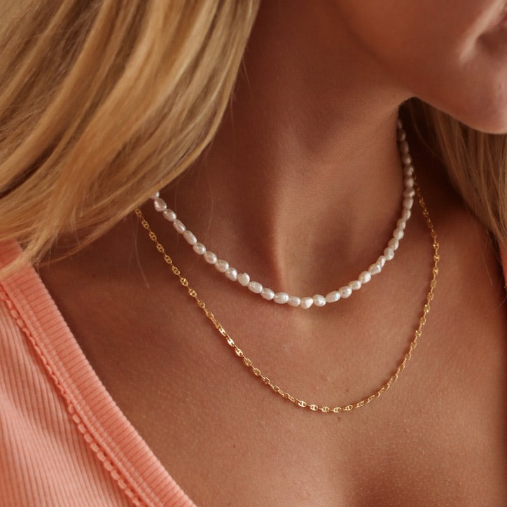 model wearing 14k gold fill chain necklace with handmade pearl beaded necklace