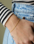 Model wearing 14k gold fill Heart Bracelet.