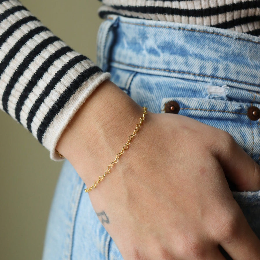 Model wearing 14k gold fill Heart Bracelet.