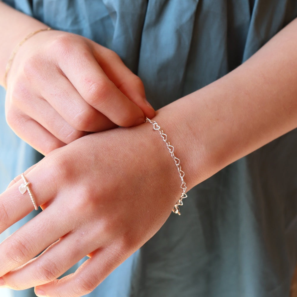 925 sterling silver heart link chain in children&#39;s sizes, photographed on a young girl&#39;s wrist