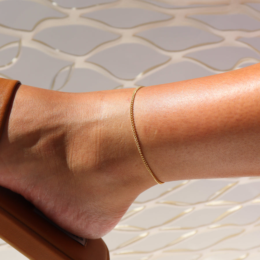 Model wearing 14k gold fill La mer anklet