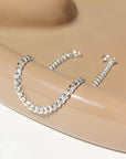925 sterling silver cuban style chain link bracelet, laid out on a curvy ceramic dish  Edit alt text
