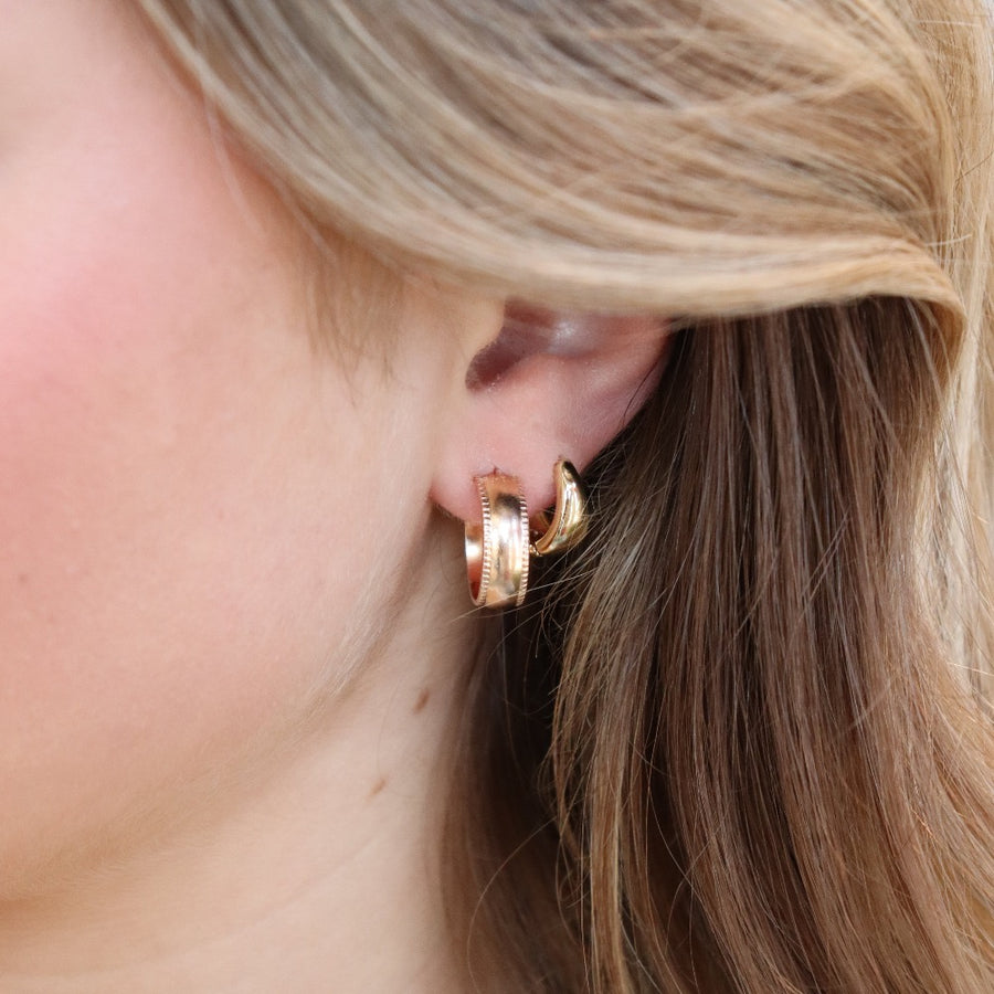 sterling silver small hoop stud earrings featuring a textured outside band, photographed on a blonde model | handmade by Token Jewelry in Eau Claire, Wisconsin