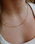 Model wearing 14k gold fill narrow link chain.