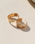 14k gold fill Florence hoops laid on a white plate in the sunlight