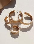 14k gold fill Florence hoops laid on a white plate in the sunlight