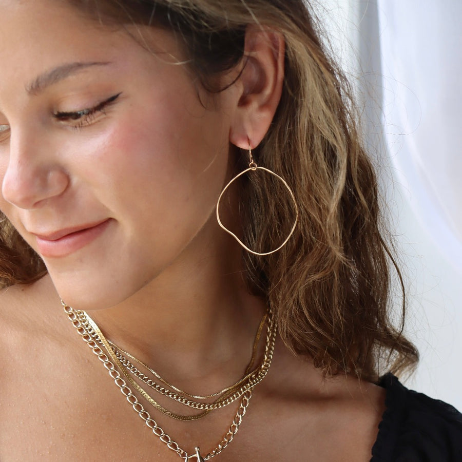 Model wearing 14k gold fill Form Hoops