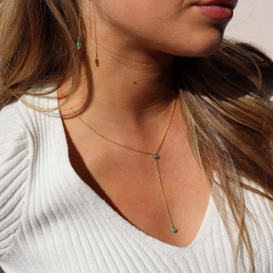 Model wearing 14k gold fill Green opal lariat. This necklace features our simple chain connected by the Green opal gemstone dangling on the lariat is another green opal lariat.