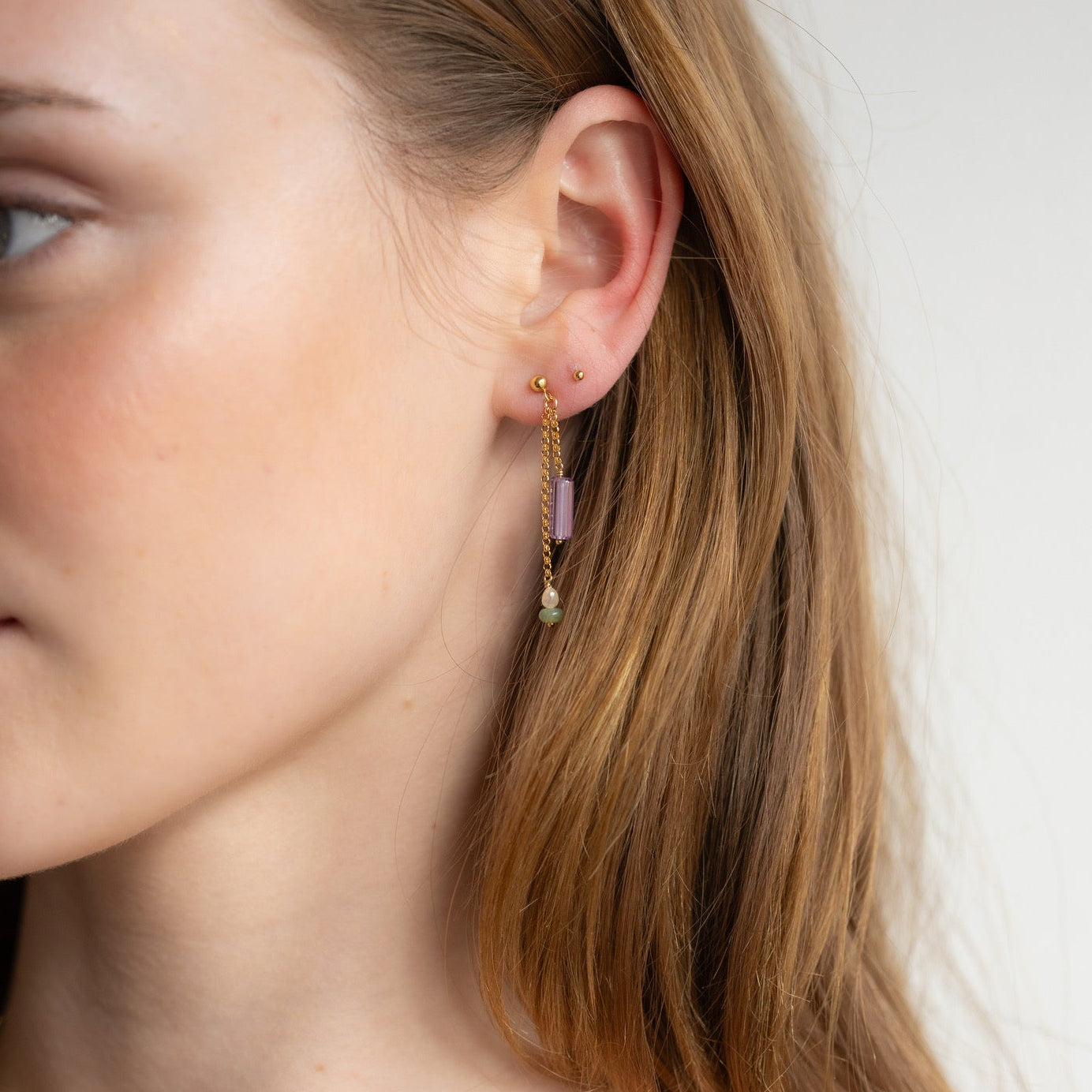 model wearing 14k gold fill chain drop earrings with gemstone beads