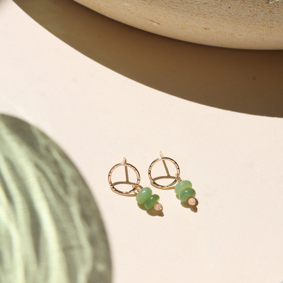 14k gold fill circle studs with opals and coral beads on a light dish