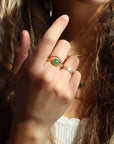 Model is wearing a 14k gold fill entwined band with a 8x10 jade gemstone in a gold bezel. Also stacked with a 14k god fill plunge ring creating the perfect stack. 