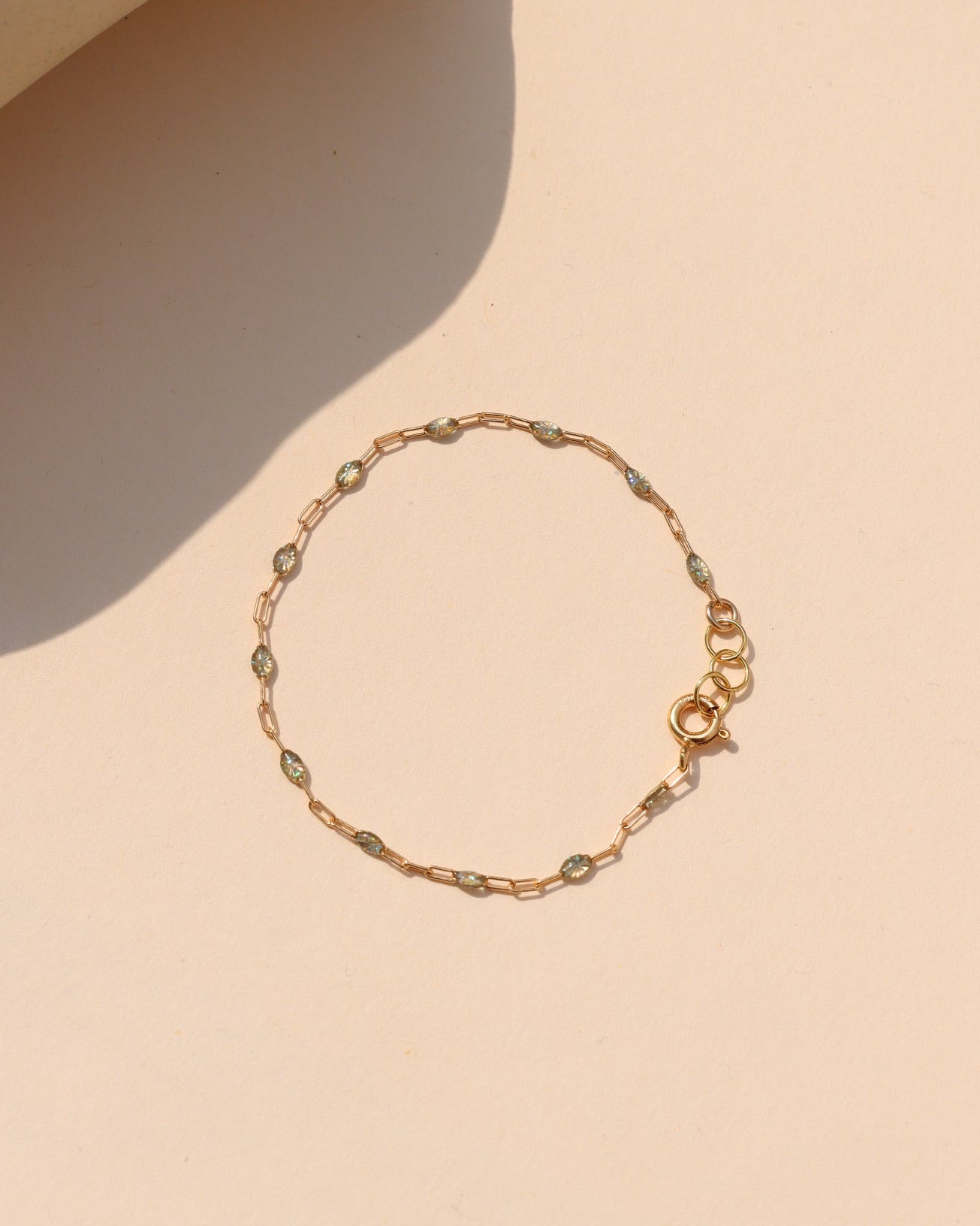 Labradorite Gemlink Bracelet with iridescent labradorite gemstones and delicate gold-filled links on a warm cream background.