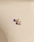 14k gold fill bezel ear posts with 4mm lapis lazuli stones on a light background