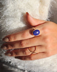 Lapis Lazuli Gemstone Ring in 14k gold fill photographed on a model wearing white. Lapis Lazuli Gemstone Ring in sterling silver. This ring features a thick gold hammered band with a 12x16mm Lapis gemstone. 