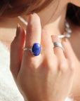 Lapis Lazuli Gemstone Ring in sterling silver photographed on a model. Lapis Lazuli Gemstone Ring in sterling silver. This ring features a thick silver hammered band with a 12x16mm Lapis gemstone. 