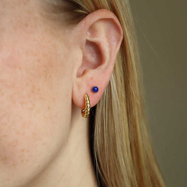 model wearing 14k gold fill braided huggie hoops with lapis lazuli studs