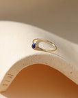 14k gold fill bezel set ring with a 4mm lapis cab in the sunlight