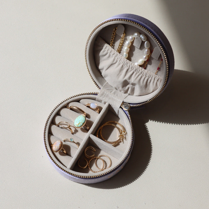 large lavender jewelry travel case opened with various 14k gold fill and gemstone jewelry
