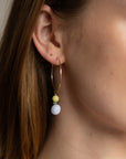 model wearing 14k gold fill hammered hoop earrings with jade and blue lace agate gemstone charms