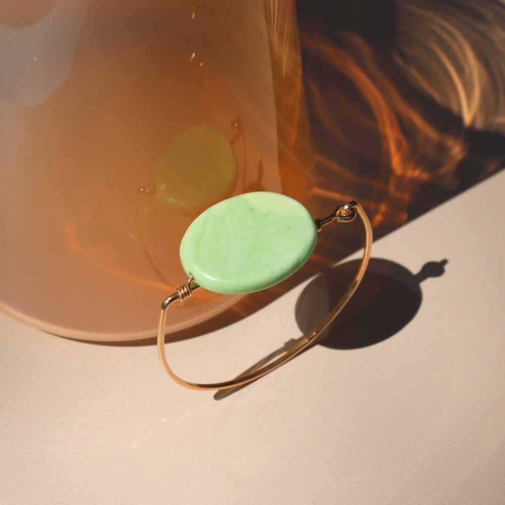 14k gold fill wire bracelet with oval chrysoprase stone in the sunlight