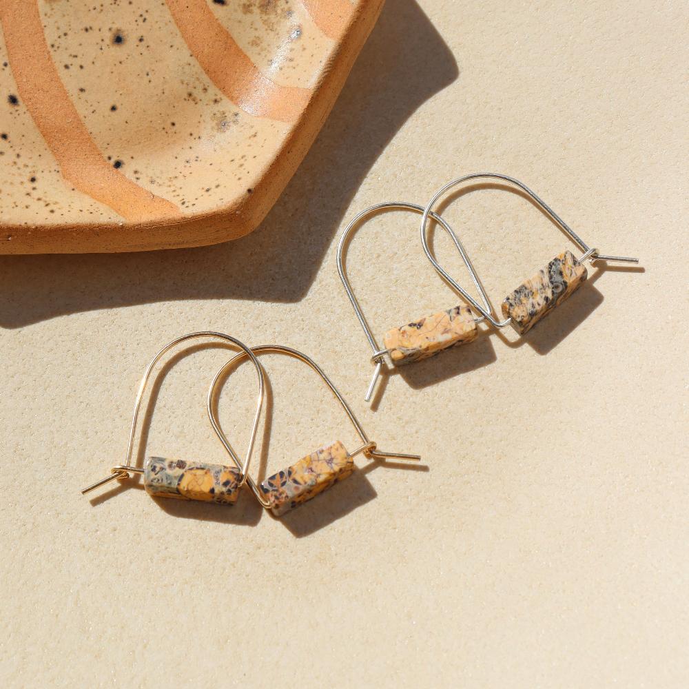 14k gold fill and sterling silver hand shaped arch earrings with leopard jasper stones on a light background