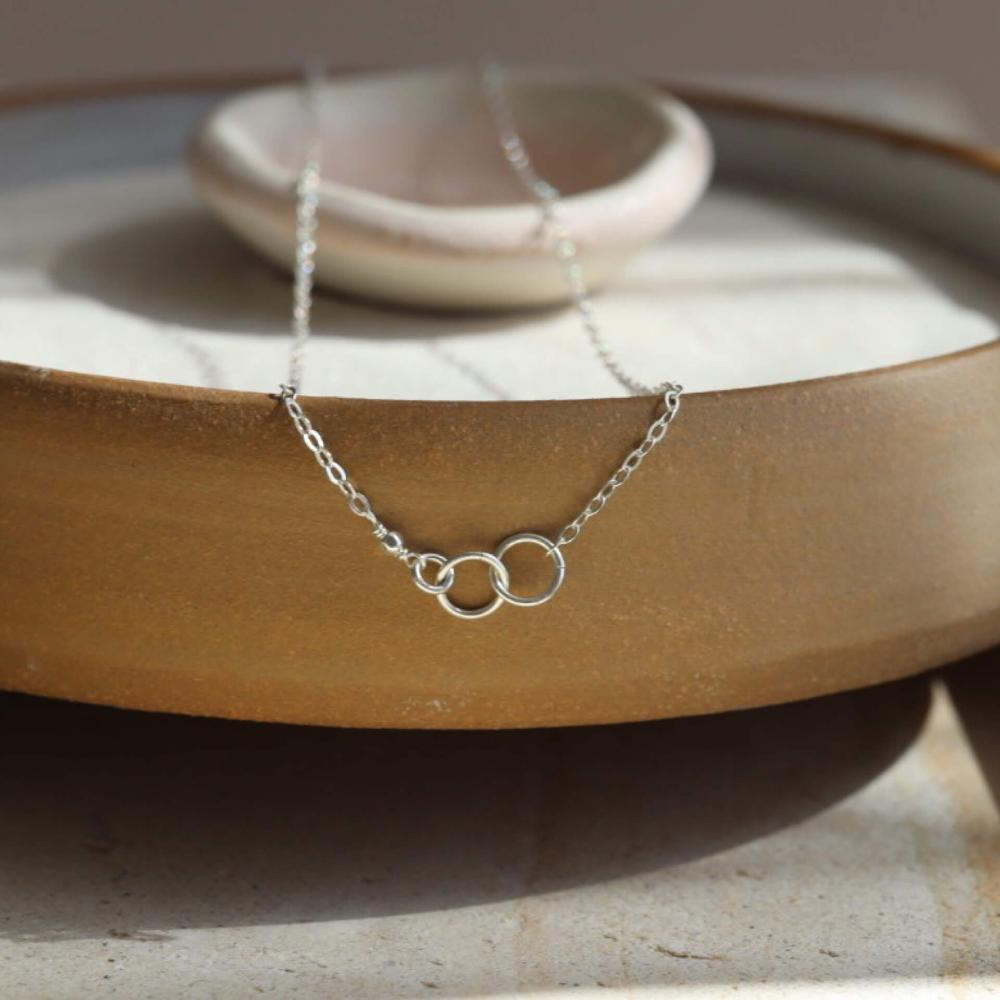 sterling silver delicate chain necklace with jump rings signifying a family lneage