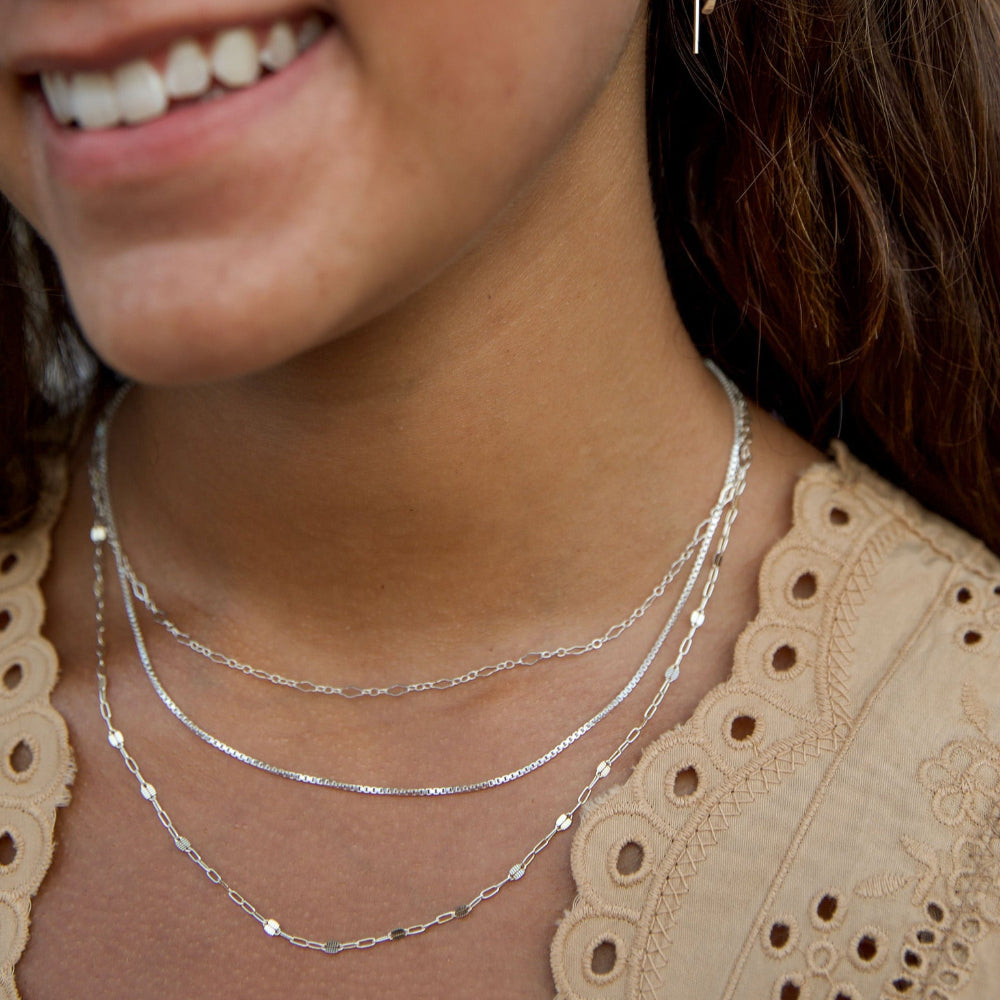 model wearing sterling silver chain necklaces layered