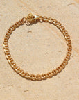 Marina Bracelet set out on a stoneware plate in the sun.