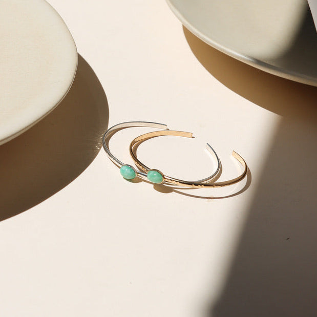 14k gold fill and sterling silver cuffs with oval amazonite gemstones on a light surface