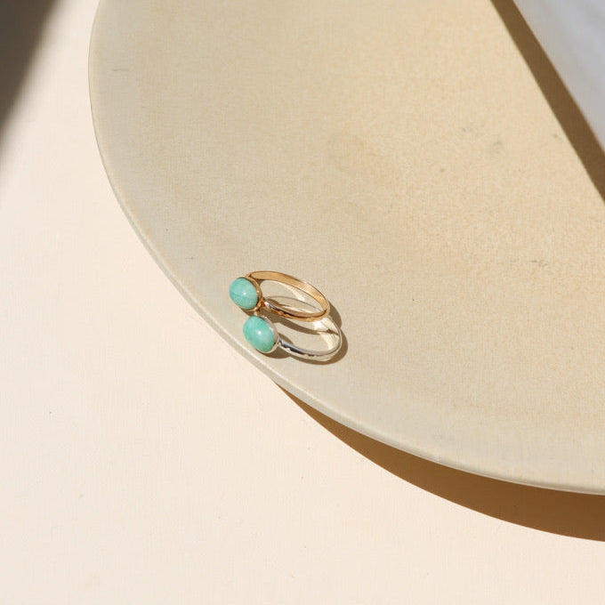 14k gold fill and sterling silver rings with oval amazonite stones on a light surface
