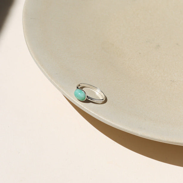 sterling silver ring with oval amazonite stones on a light surface