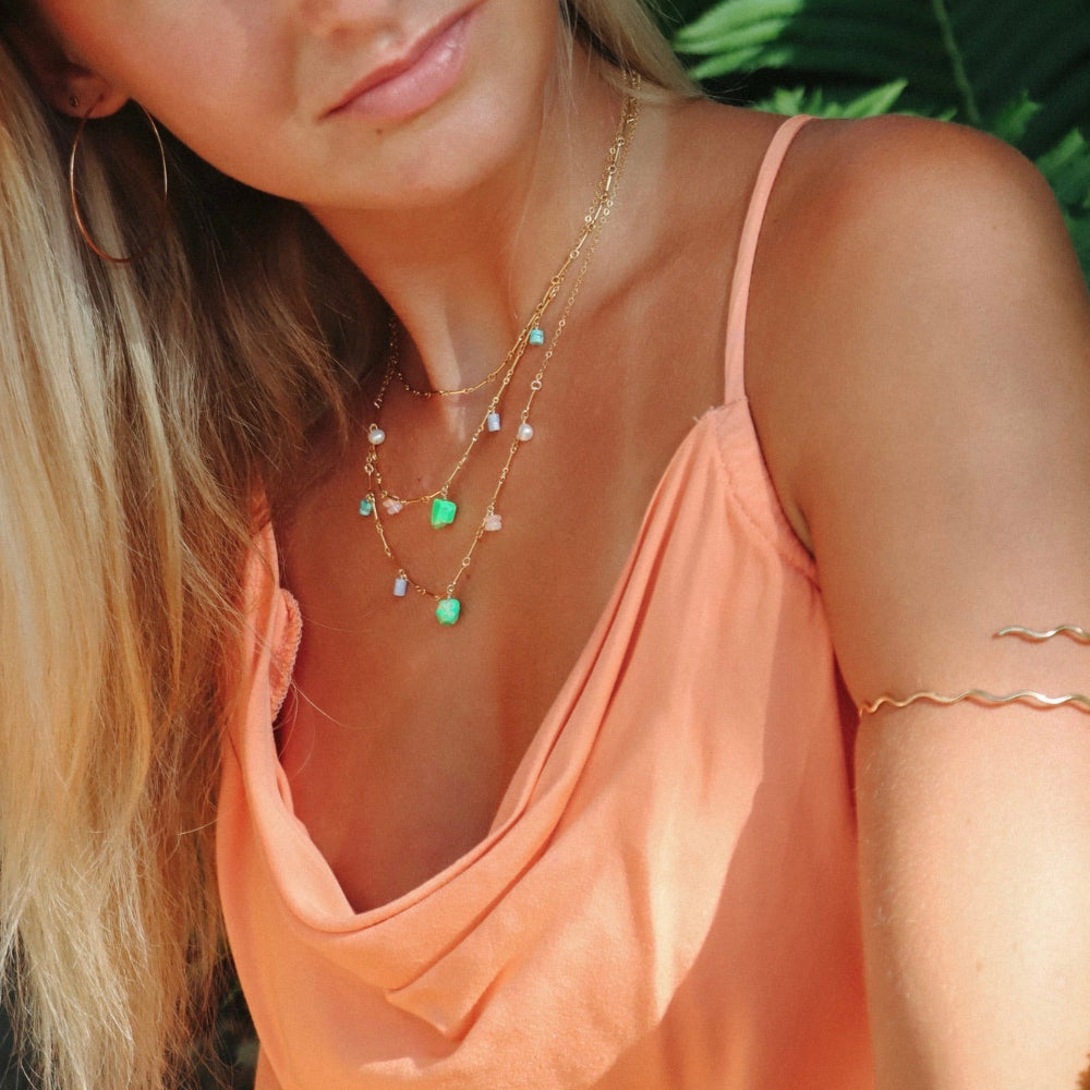 model wearing 14k gold fill chain necklace with gemstone charms 