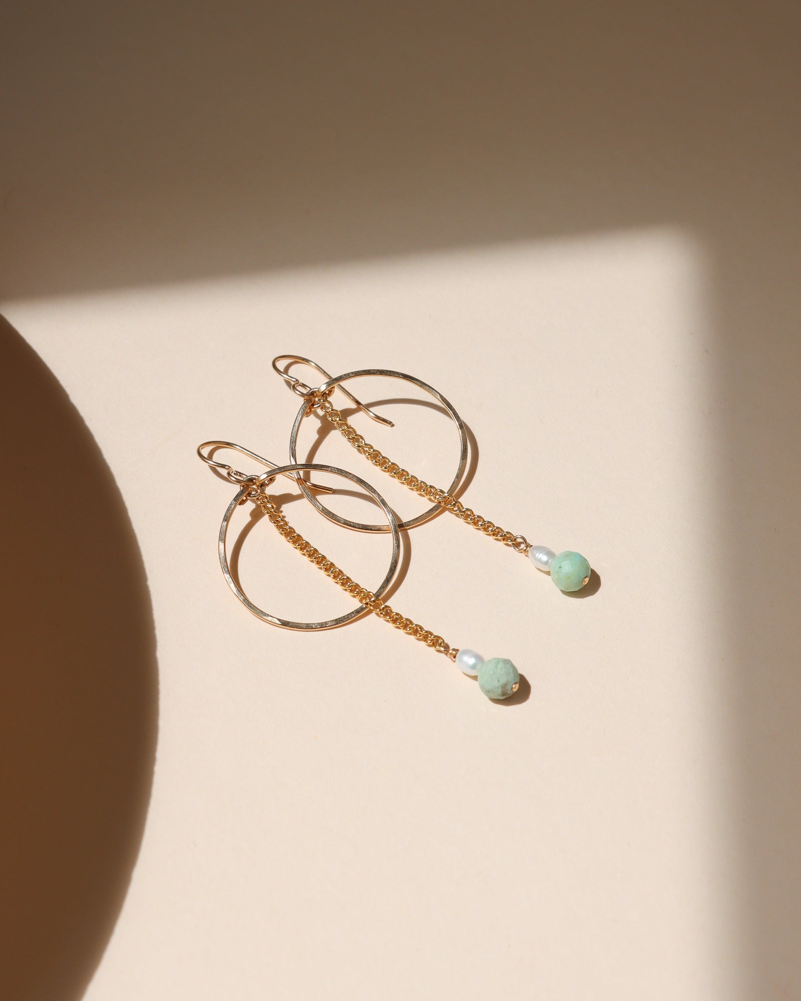 14k gold fill hoops with chain, pearl, and turquoise beads in the sunlight