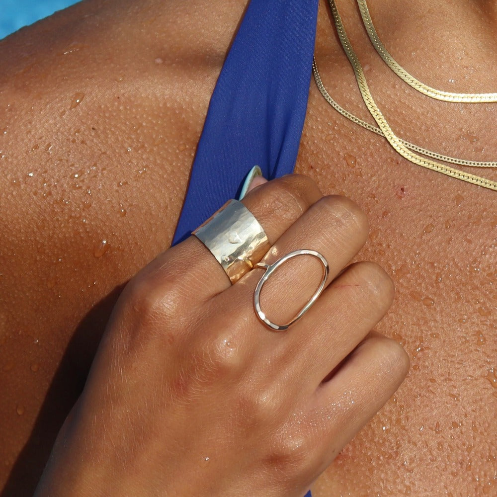 14k gold filled olivia ring paired with cuff ring on a model that is in water.