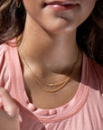 Model found wearing 14k gold fill Gemma Chain  paired with the narrow link chain.
