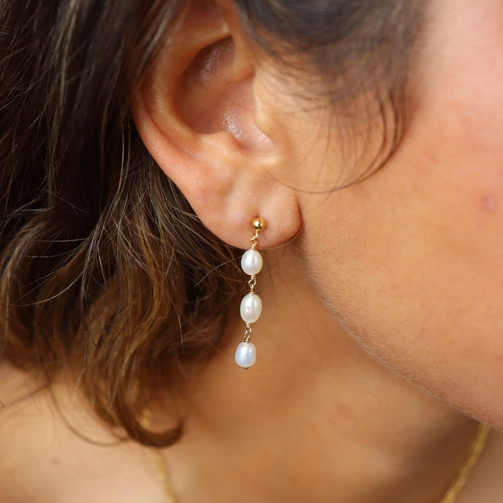 Model wearing Trillium Pearl Drop Earrings