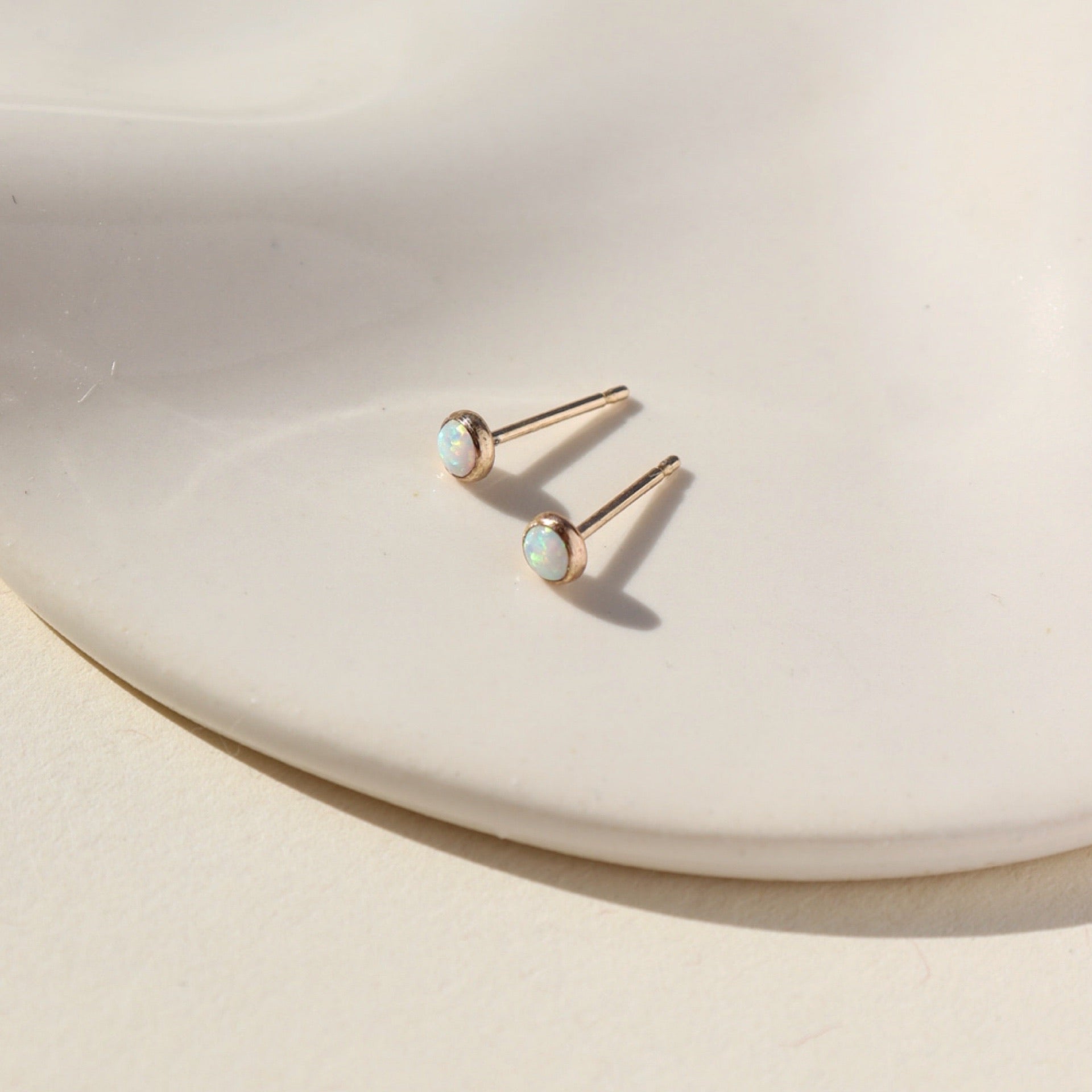 14k gold fill Opal Studs on a white plate