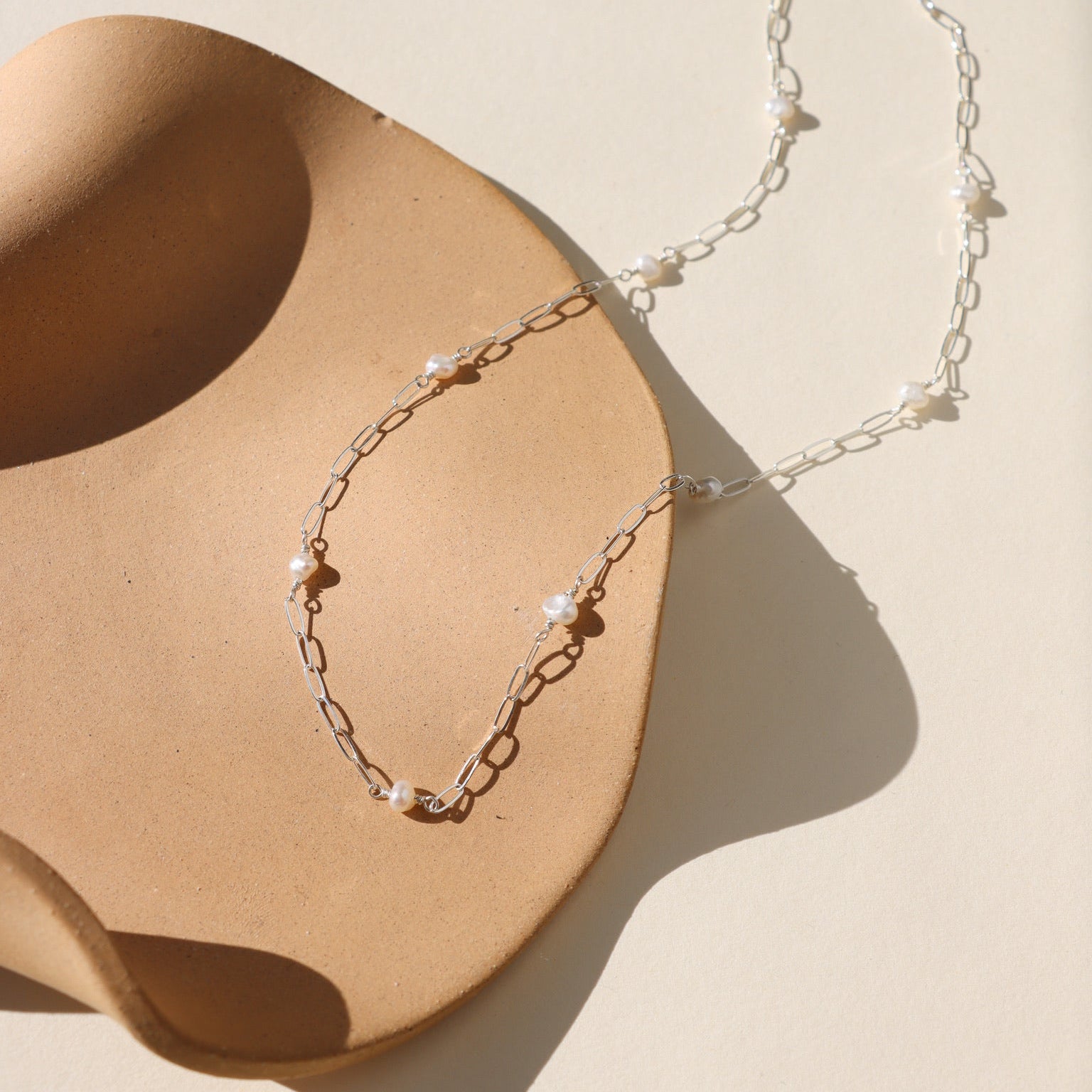 Sterling silver  Cosette chain necklace accented with a single lustrous freshwater pearl.