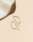 14k gold fill, P shaped threaders displayed on a cream backdrop 
