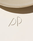 Sterling Silver, P shaped threaders displayed on a cream backdrop 