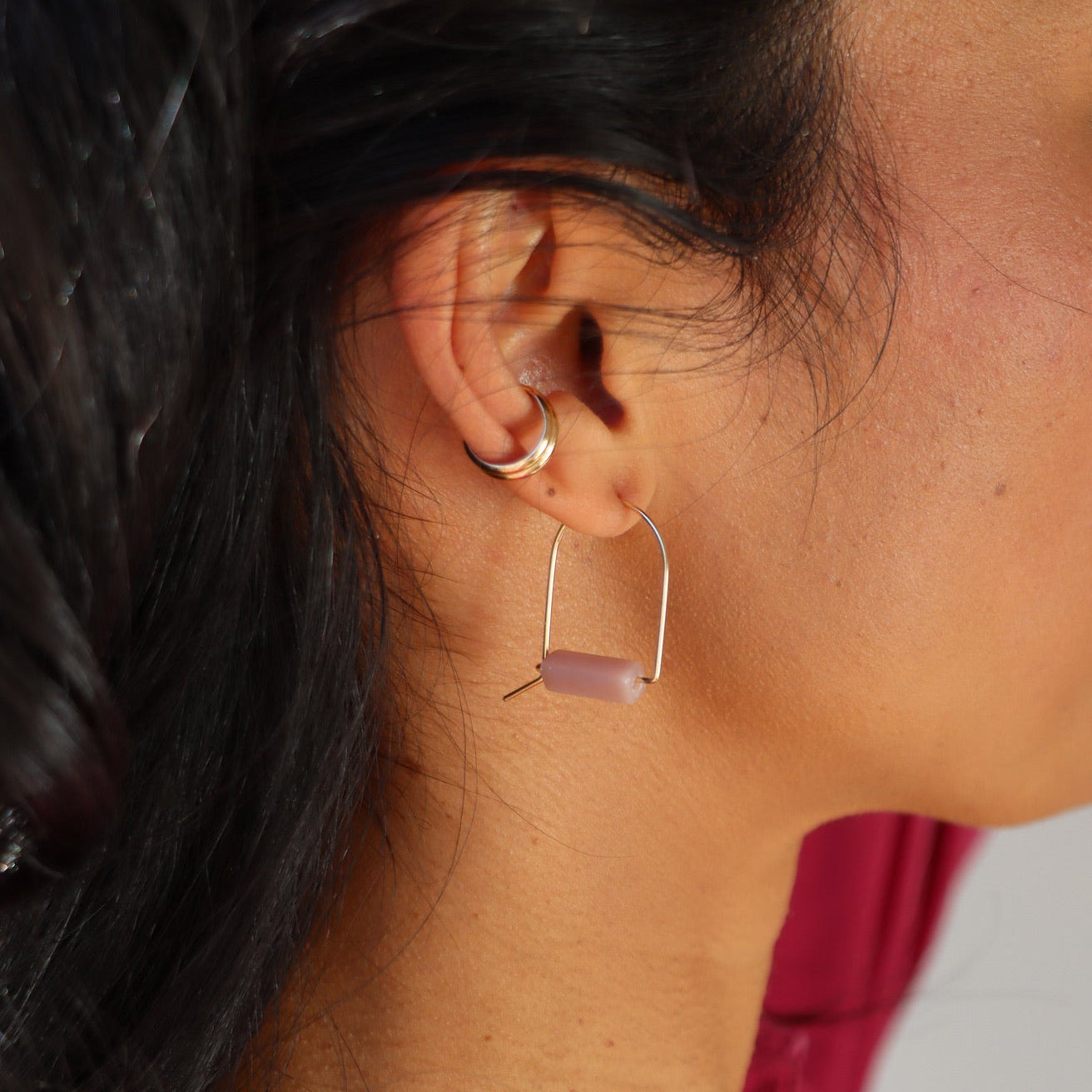 model wearing pink opal arches in sterling silver pair with sterling silver ear cuff