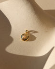 Pink Pearl Locket on tan dish in sunlight