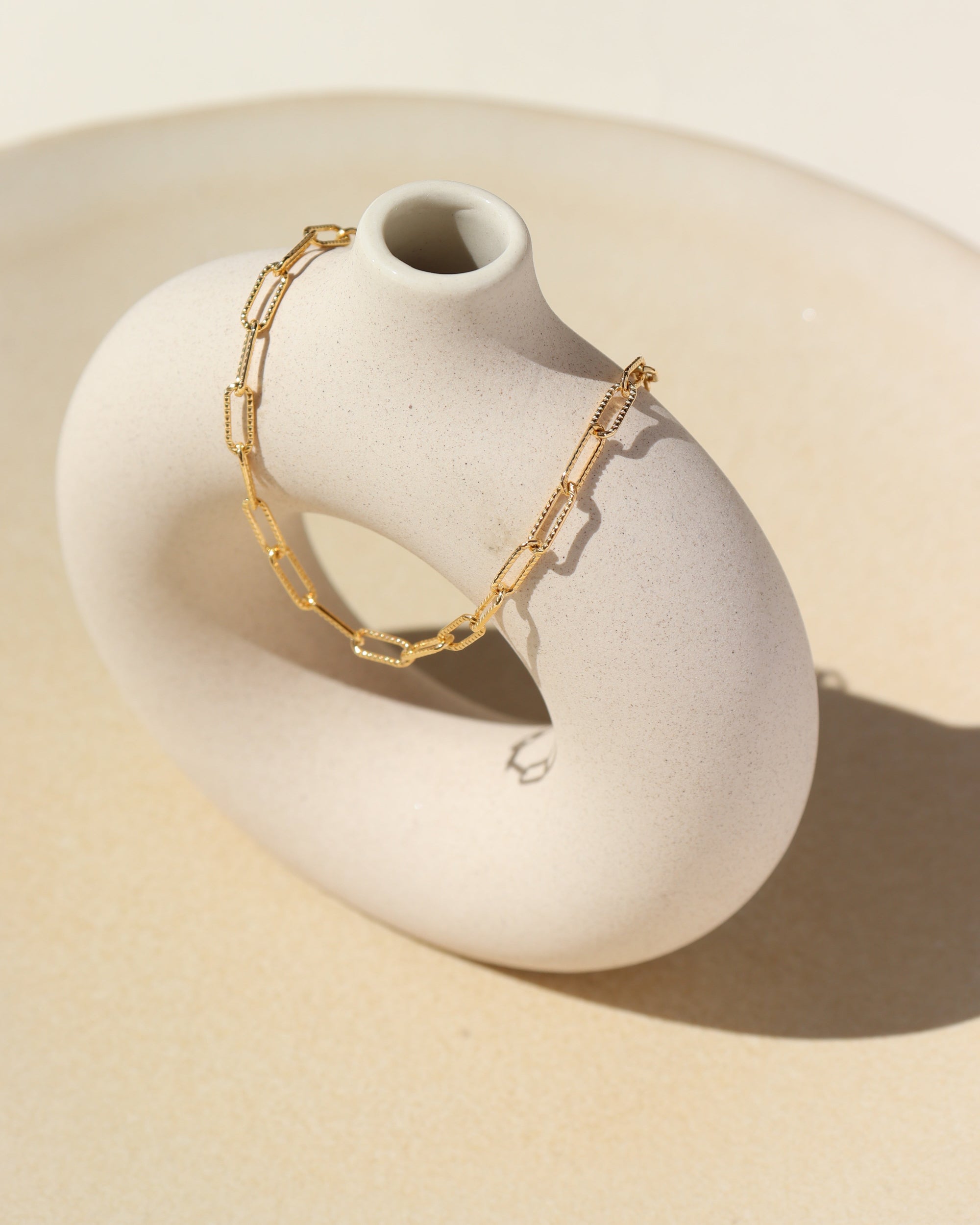 14k gold fill piper anklet on a light vase