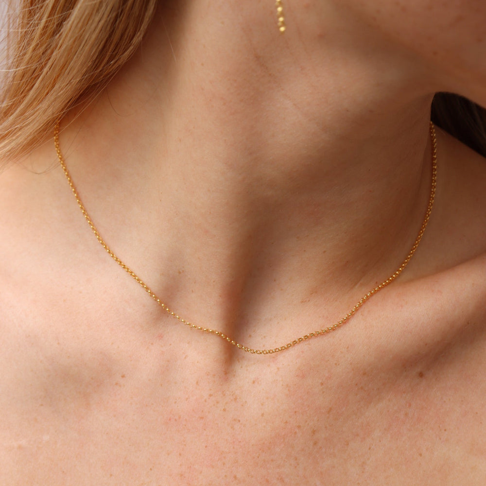 Remy chain necklace in 14k gold fill featuring delicate beaded chain links, worn on a model as a minimalist everyday layering necklace.