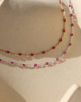 ruby enamel link with 14k gold fill and sterling silver chain on display in the sunlight with a cream backgound
